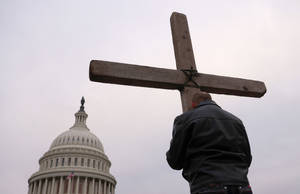 Man Clutching Christian Cross Symbols Wallpaper