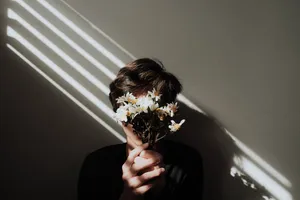 Man Holding Flowers Aesthetic Wallpaper