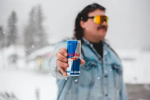 Man Holding Red Bull In Winter Wallpaper