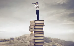 Man On Book Stack Wallpaper