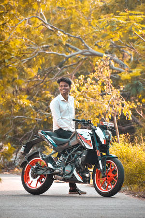 Man Sitting On A Ktm Duke 200 Wallpaper