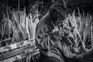 Man Struggling With Smoking Addiction In Monochrome Wallpaper