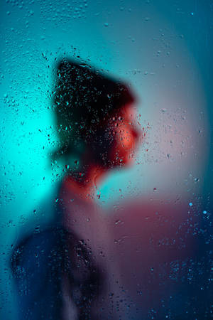 Man With A Bonnet On Behind A Misty Glass Profile Wallpaper