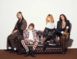 Maneskin Seated On Fancy Leather Couch Wallpaper