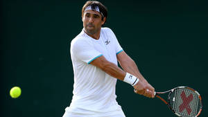 Marcos Baghdatis Expertly Preparing To Counter An Incoming Ball During A Tennis Match. Wallpaper