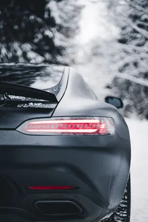 Matte Black Car Winter Drive Wallpaper