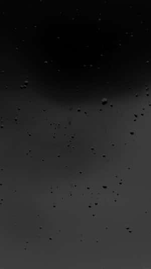 Matte Blacki Phonewith Water Droplets Wallpaper