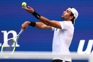 Matteo Berrettini In Action During A Tennis Game Wallpaper