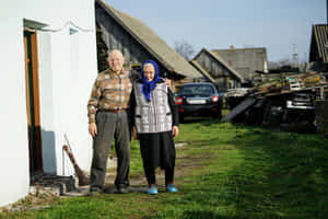 Mature Couple Posing For A Picture Wallpaper