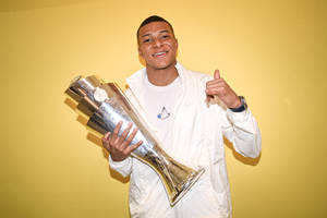 Mbappe With Uefa Trophy Wallpaper