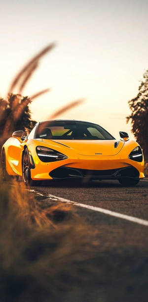 Mclaren 720s Phone Yellow Aesthetic On Road Wallpaper