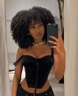 Mesmerizing Beauty In Bold - A Beautiful Black Woman In Corset Wallpaper