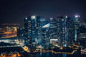 Mesmerizing City Night Showcasing The Reflective River Wallpaper