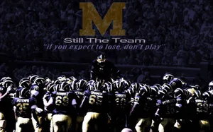 Michigan Wolverines Football Team Charging On The Field Wallpaper
