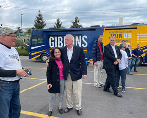 Mike Gibbons Embracing A Woman In An Friendly Event Wallpaper