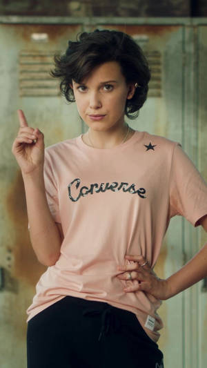 Millie Bobby Brown In Converse Shirt Wallpaper