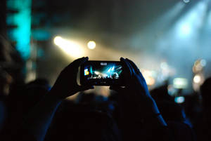 Mobile Phone Capturing Concert Moments Wallpaper