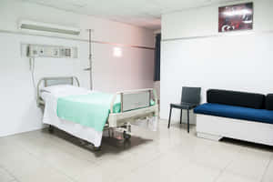 Modern Hospital Bed In A Well-lit, White Room Wallpaper