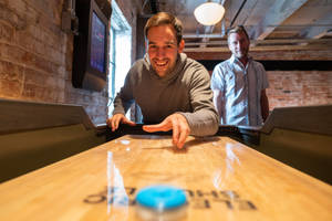 Modern Shuffleboard Table With Blue Puck Wallpaper