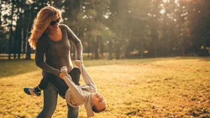 Mom Carrying Boy Wallpaper