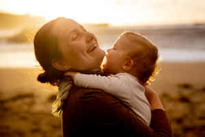 Mother Child Sunset Embrace Wallpaper