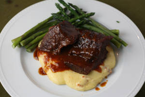 Mouth Watering Short Ribs Served Over Creamy Polenta Wallpaper