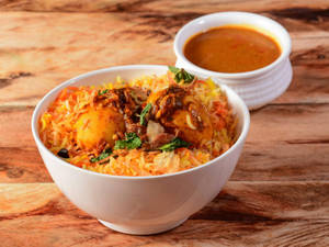 Mouthwatering Biryani In White Bowl Wallpaper