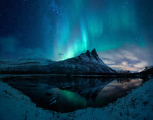 Mystical Aurora Borealis Paints A Breathtaking Scene Across The Night Sky Wallpaper