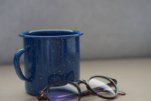 Navy Blue Mug And Eyeglasses Wallpaper