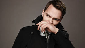 Nicholas Hoult Brushing Nose Wallpaper