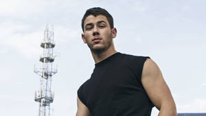 Nick Jonas Commanding Attention In A Sleeveless Tee. Wallpaper