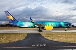 Ocean Blue Icelandair Airplane On Runway Wallpaper