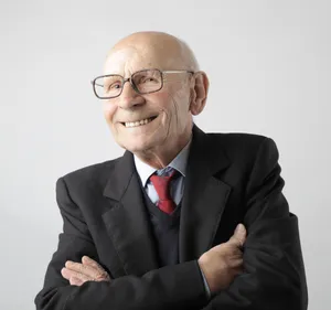 Old Man Smiling In A Black Suit Wallpaper