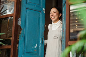 Older Woman Opening The Door Wallpaper