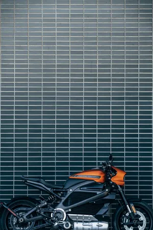 Orange Harley Davidson Motorcycle In Action Wallpaper