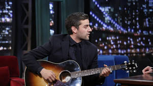 Oscar Isaac Playing Guitar Wallpaper