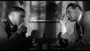 Oskar Schindler And Amon Goeth In A Poignant Scene From Schindler's List Wallpaper