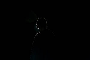 Outline Of A Man Profile On Black Backdrop Wallpaper