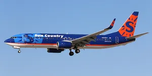 Pale Blue Sky Over A Sun Country Aircraft Wallpaper