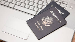 Passport On Silver Laptop Wallpaper