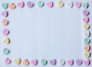 Pastel Pink Heart Candies Forming Border Wallpaper
