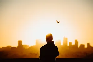 Peaceful Relaxing Man And Cityscape Wallpaper
