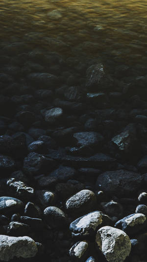 Pebbles In Lake Smartphone Background Wallpaper