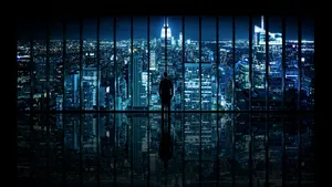 Pensive Man Contemplating City Through A Window With A 4k Tv Reflection Wallpaper