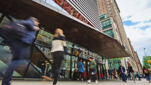 People Walking In Front Of The New School Wallpaper