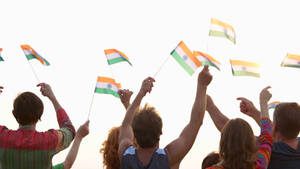 People Waving A Miniature Indian Flag Wallpaper