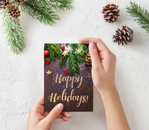 Person Holding Holiday Card Wallpaper