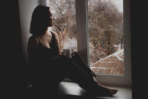 Pessimistic Woman By Window Wallpaper