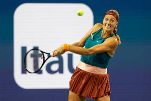 Petra Kvitova Smiling While Hitting Ball Wallpaper