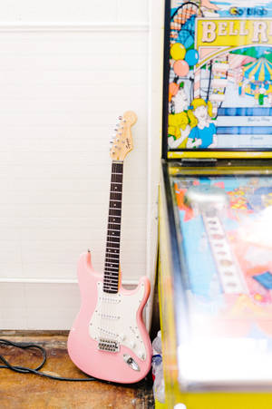 Pink Electric Guitar Besides Pinball Wallpaper